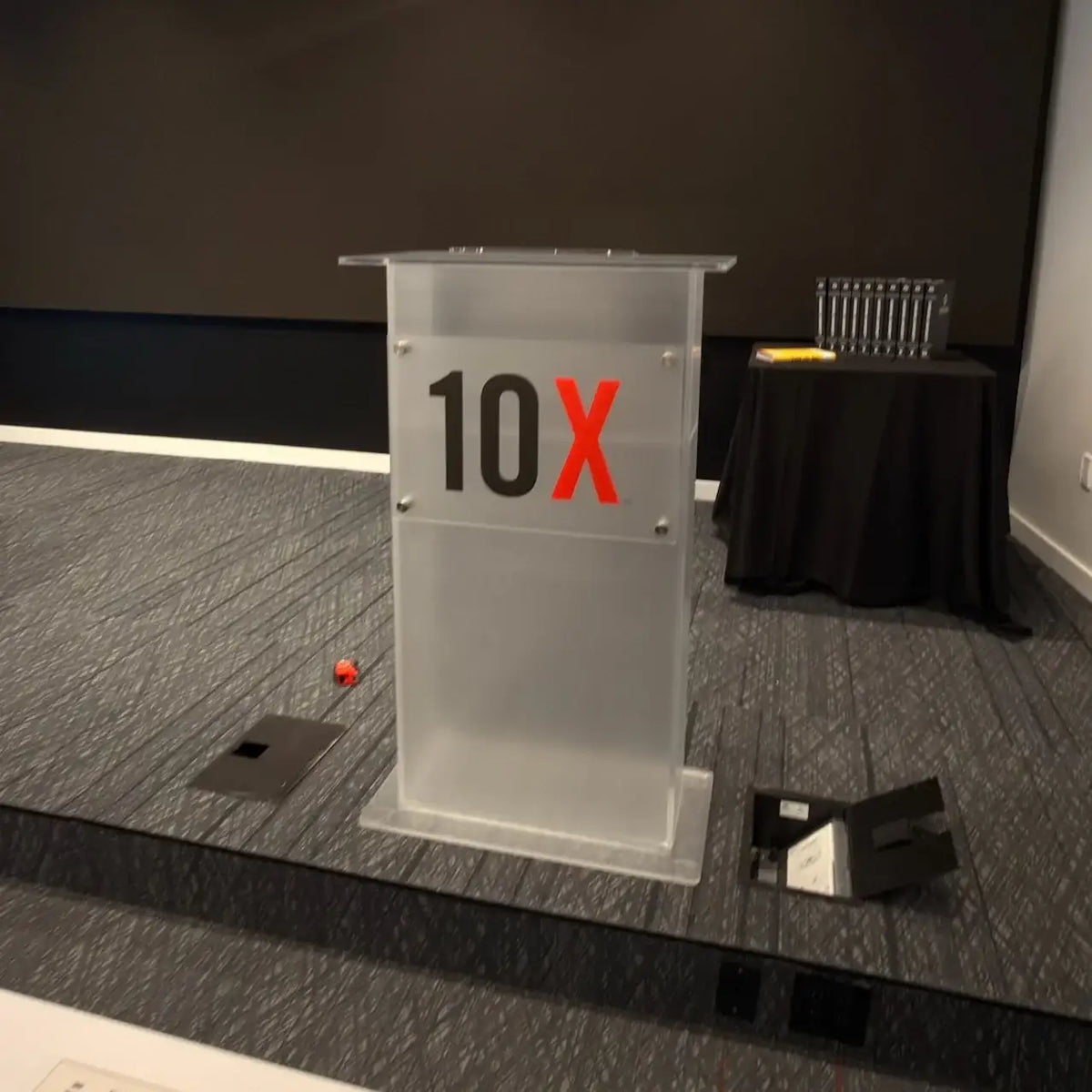 Clear acrylic podium by South Florida Acrylics featuring a custom 10X logo panel.