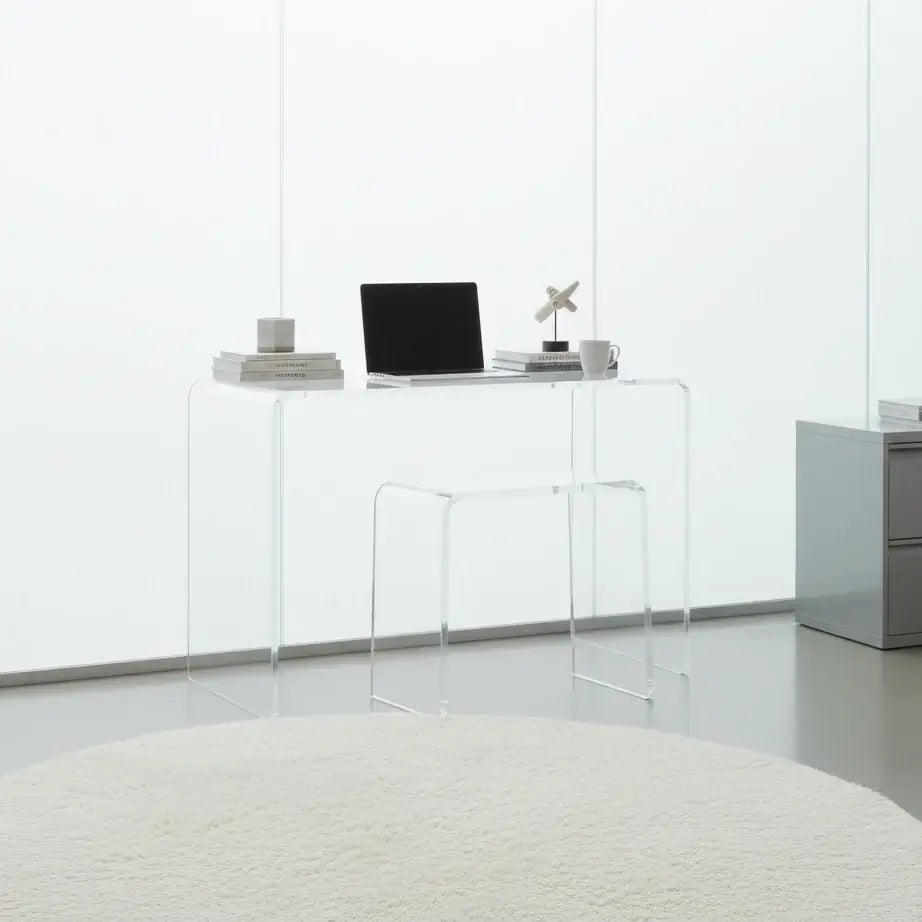 Clear acrylic waterfall vanity stool paired with a modern desk in a minimalist home office setting.
