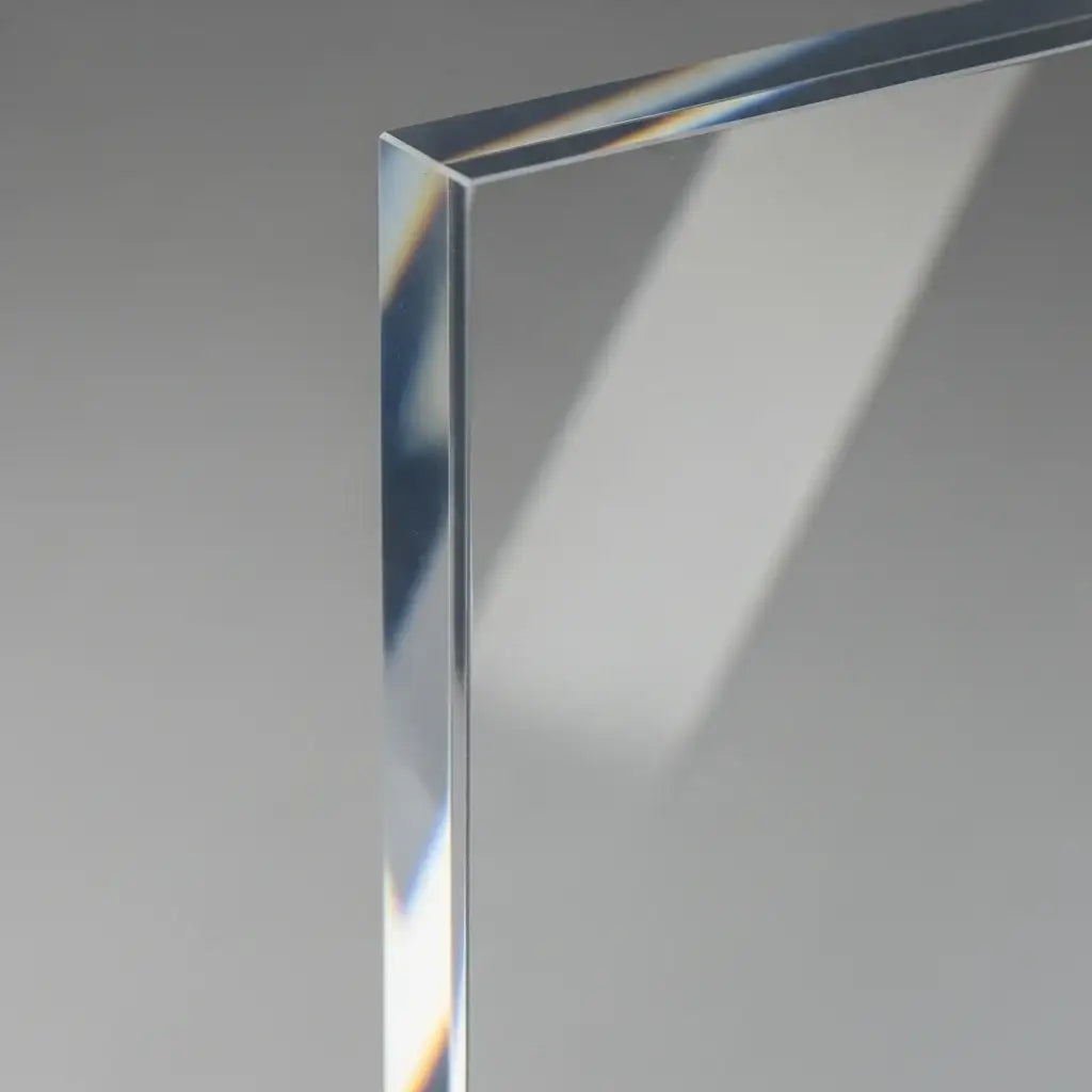 Close-up of a polished, clear acrylic sheet edge showing high transparency and precise custom fabrication.